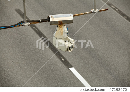 Security camera operating over the road, daytime. 47192470