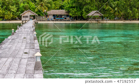 Pier of Dive Station - Kri Island. Clound above Gam in Background. Raja Ampat, Indonesia, West Papua Pier of Dive Station - Kri Island. Clound above Gam in Background. Raja Ampat, Indonesia, West Papua 47192557