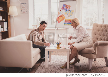 Positive delighted therapist working with great pleasure 47192732