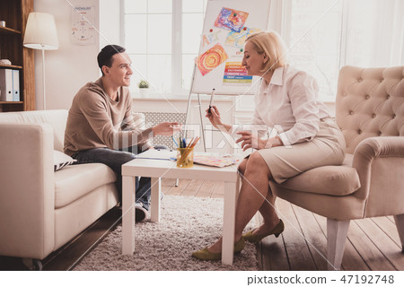 Pleased blonde woman giving highlighter to her client 47192748