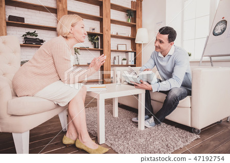 Positive delighted male person listening to his therapist Positive delighted male person listening to his therapist 47192754