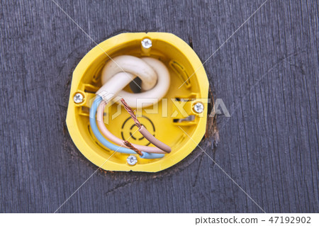 Yellow outlet box for wall socket, close-up. 47192902