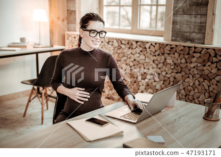 Joyful nice woman working in the office Joyful nice woman working in the office 47193171