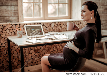Delighted pregnant woman thinking about her future child 47193172