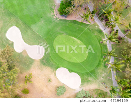 Birds eye view of golf course hole green and sand traps. Birds eye view of golf course hole green and sand traps. 47194169