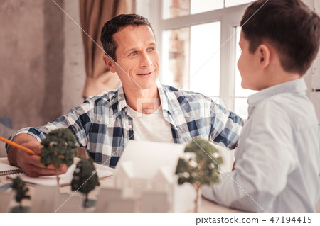 Blue-eyed foster father listening to his adopted kid Blue-eyed foster father listening to his adopted kid 47194415