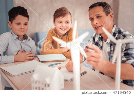 Smart tutor telling his pupils about windmills Smart tutor telling his pupils about windmills 47194540