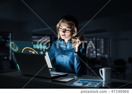 Beautiful blonde working on laptop and infographs out of screen. Beautiful blonde working on laptop and infographs out of screen. 47198968