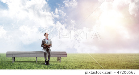 Young businessman or student studying the science in summer park Young businessman or student studying the science in summer park 47200563
