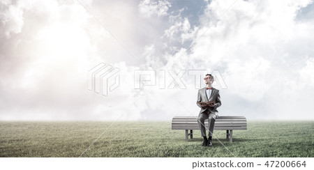 Young businessman or student studying the science in summer park Young businessman or student studying the science in summer park 47200664