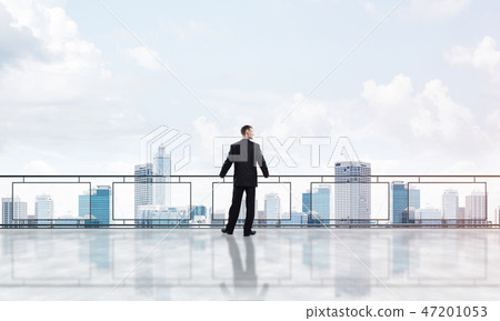 Sunrise above skyscrapers and businessman facing new day Sunrise above skyscrapers and businessman facing new day 47201053