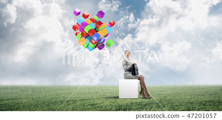 Attractive business lady or accountant outdoors on white box Attractive business lady or accountant outdoors on white box 47201057