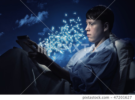 Reading in bed 47201627