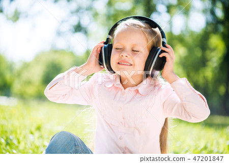 Kid relaxing in park Kid relaxing in park 47201847