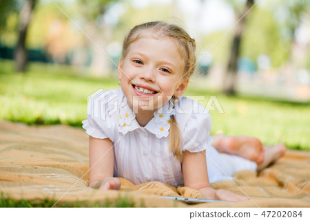 Girl in summer park 47202084