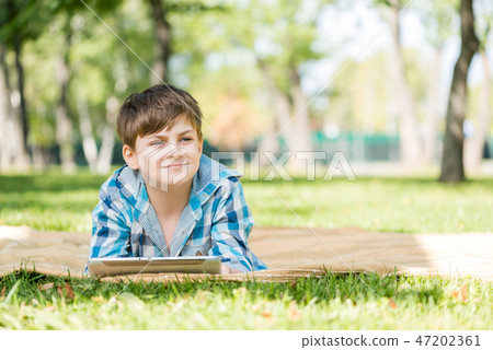 Boy in summer park Boy in summer park 47202361