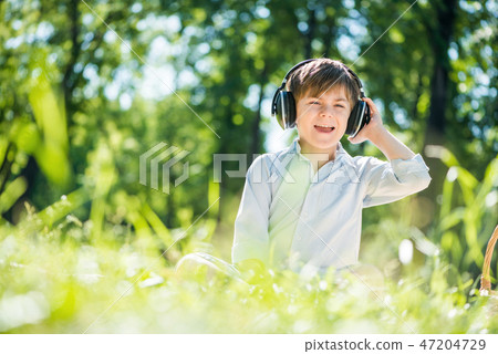 Boy enjoying music Boy enjoying music 47204729