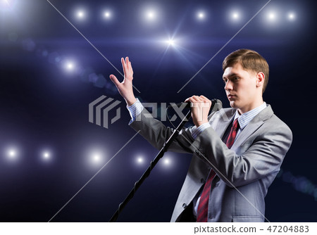 Businessman with microphone 47204883
