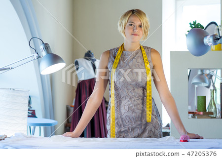 Seamstress in atelier studio Seamstress in atelier studio 47205376