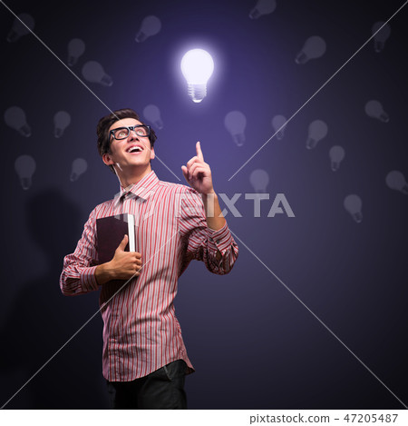young man holding a book young man holding a book 47205487