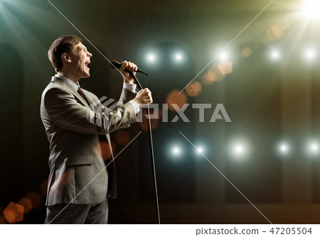 Businessman with microphone Businessman with microphone 47205504