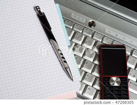 Business. Phone and notepad on laptop. Business. Phone and notepad on laptop. 47206305