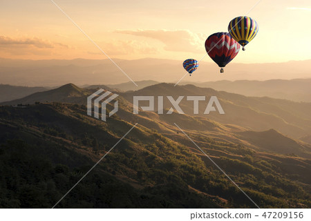 Hot air balloon flying over doi Chang at sunset Hot air balloon flying over doi Chang at sunset 47209156