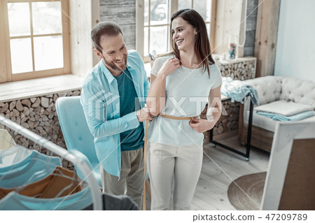 Couple of fashion designers laughing while working together 47209789