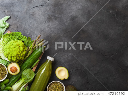 Assorted green toned raw organic vegetables 47210592