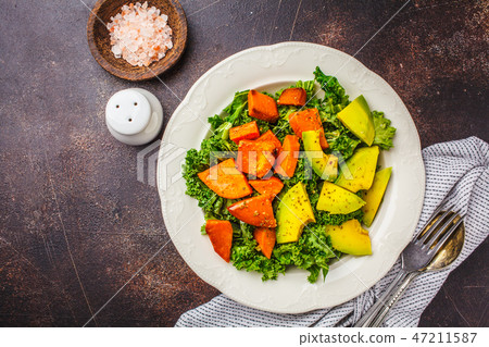 Healthy green kale salad with avocado  47211587
