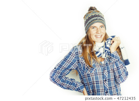 young pretty blond teenage girl in winter hat and scarf on white background smiling 47212435