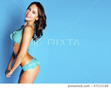 Brunette babe in blue lingerie, smiling Stock Photo