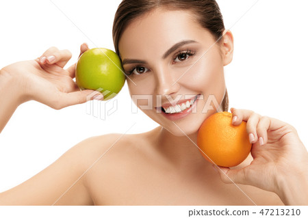 portrait of attractive caucasian smiling woman isolated on white studio shot eating green apple portrait of attractive caucasian smiling woman isolated on white studio shot eating green apple 47213210