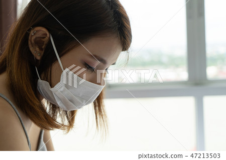 Woman wearing face mask protect pm25 air pollution 47213503
