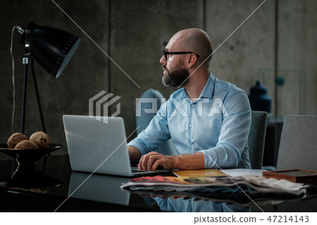 Middle-aged designer working in office Middle-aged designer working in office 47214143