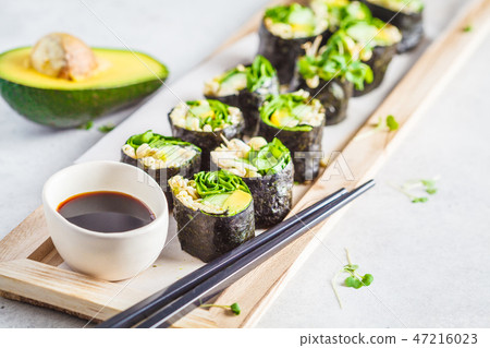 Vegan green sushi rolls with avocado, sprouts Vegan green sushi rolls with avocado, sprouts 47216023