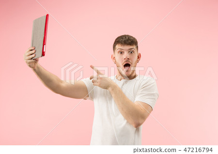 portrait of smiling man pointing at laptop with blank screen isolated on white portrait of smiling man pointing at laptop with blank screen isolated on white 47216794