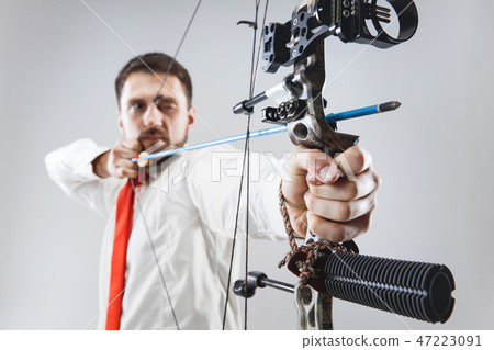 Businessman aiming at target with bow and arrow, isolated on white background Businessman aiming at target with bow and arrow, isolated on white background 47223091