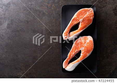 Fresh salmon fish steaks on black background 47224455