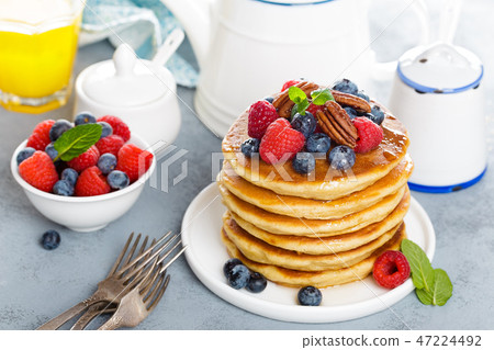 Stack of fluffy pancakes with fresh berries Stack of fluffy pancakes with fresh berries 47224492