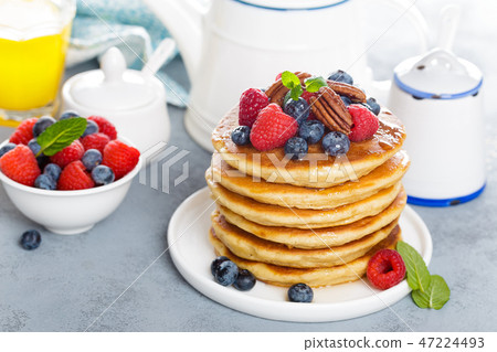 Stack of fluffy pancakes with fresh berries Stack of fluffy pancakes with fresh berries 47224493