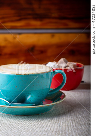 Beautiful Delicious Latte art, Blue coffee cup with Brown sugar on wooden background. Beautiful Delicious Latte art, Blue coffee cup with Brown sugar on wooden background. 47224852