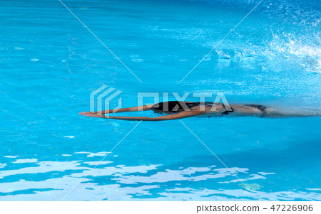 Woman swimming in open air swim pool Woman swimming in open air swim pool 47226906