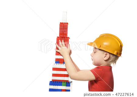 Blond boy in construction helmet and red t-shirt 47227614