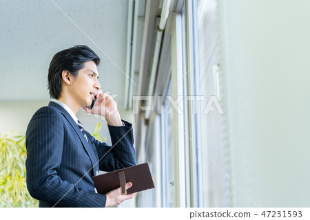 Male employee who calls a young businessman Male employee who calls a young businessman 47231593