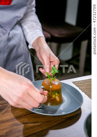 Chef decorates the aspic. Close-up 47232709