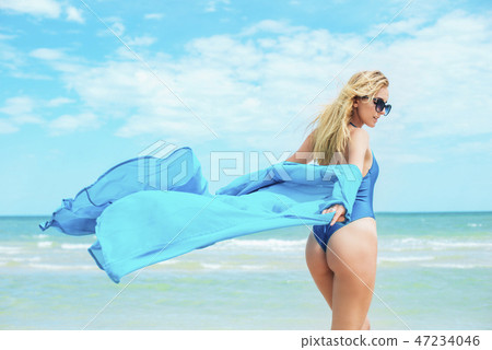 A beautiful girl in a blue swimsuit  on beach 47234046