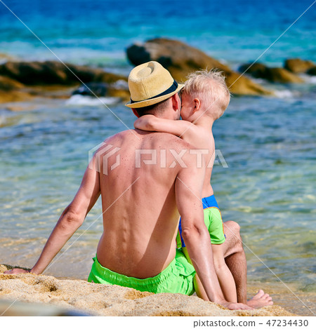 Toddler boy on beach with father Toddler boy on beach with father 47234430