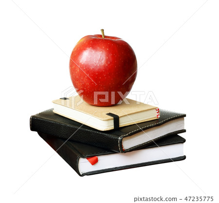 Notebooks and an apple Notebooks and an apple 47235775