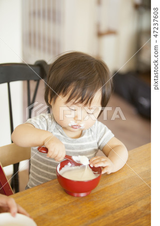 Child eating baby food Child eating baby food 47237608